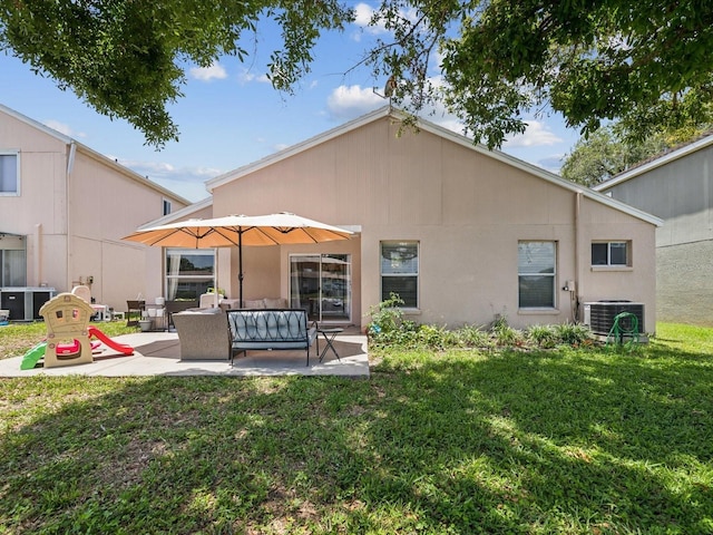 4716 Wolfram Ln, New Port Richey, FL 34653 - back of house featuring a patio, a yard, and an outdoor living space