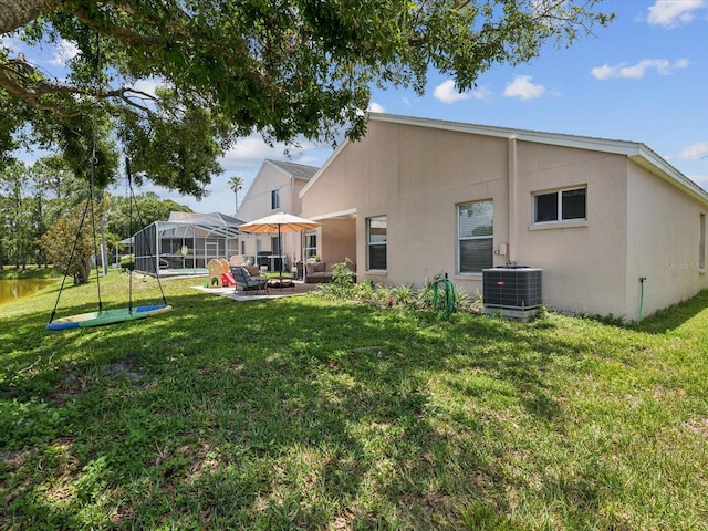 4716 Wolfram Ln, New Port Richey, FL 34653 - rear view of property with a patio area, a lawn, an outdoor living space, and stucco siding