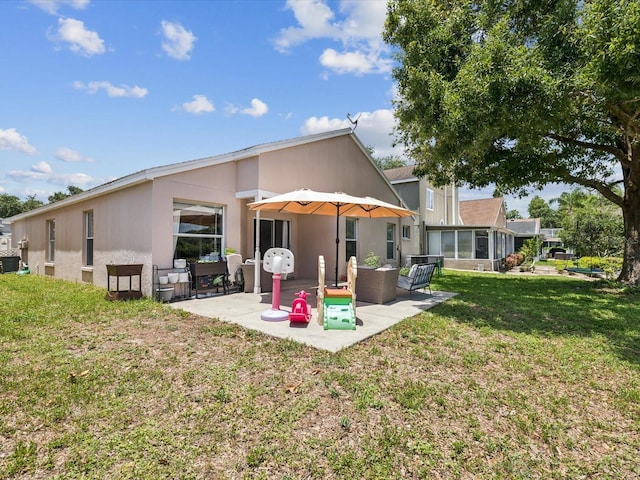 4716 Wolfram Ln, New Port Richey, FL 34653 - back of house with a patio area and a lawn