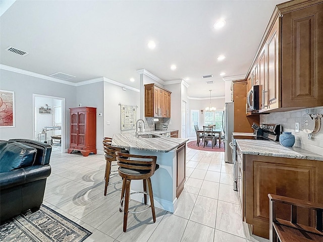 4082 Watson Dr, New Port Richey, FL 34655 - kitchen featuring appliances with stainless steel finishes, a kitchen bar, a peninsula, backsplash, and ornamental molding