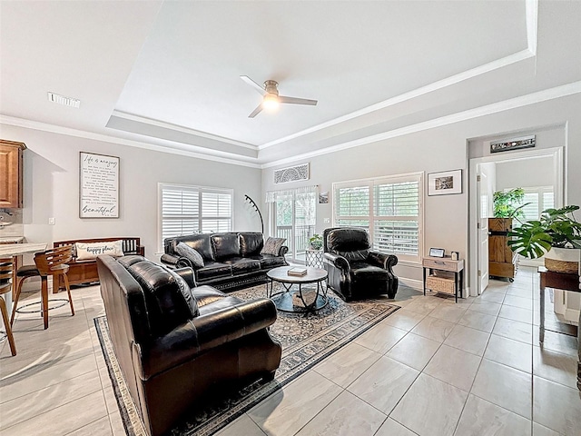 4082 Watson Dr, New Port Richey, FL 34655 - living room featuring a tray ceiling, a ceiling fan, healthy amount of natural light, crown molding, and light tile patterned floors