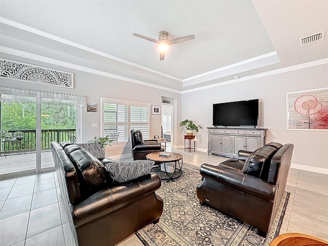 4082 Watson Dr, New Port Richey, FL 34655 - living room featuring light tile patterned floors, a tray ceiling, ceiling fan, and crown molding