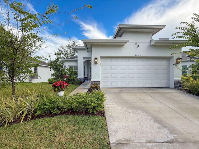 4082 Watson Dr, New Port Richey, FL 34655 - view of front of house with stucco siding, driveway, a garage, and stone siding