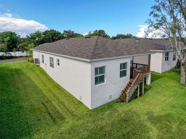 4082 Watson Dr, New Port Richey, FL 34655 - rear view of house featuring a shingled roof, stairs, central AC unit, and a lawn