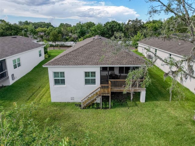 4082 Watson Dr, New Port Richey, FL 34655 - rear view of property with a shingled roof, a lawn, stairway, a sunroom, and stucco siding