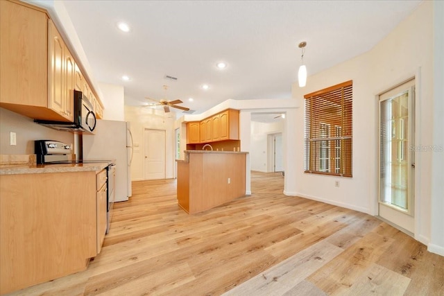 9130 Madrid Rd, Weeki Wachee, FL 34613 - kitchen featuring electric stove, stainless steel microwave, light brown cabinets, light wood-style floors, and ceiling fan