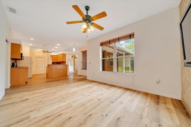 9130 Madrid Rd, Weeki Wachee, FL 34613 - unfurnished living room featuring light wood-style flooring, ceiling fan, and recessed lighting