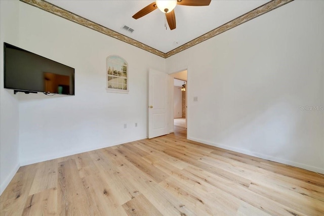 9130 Madrid Rd, Weeki Wachee, FL 34613 - spare room featuring a ceiling fan, wood finished floors, and crown molding