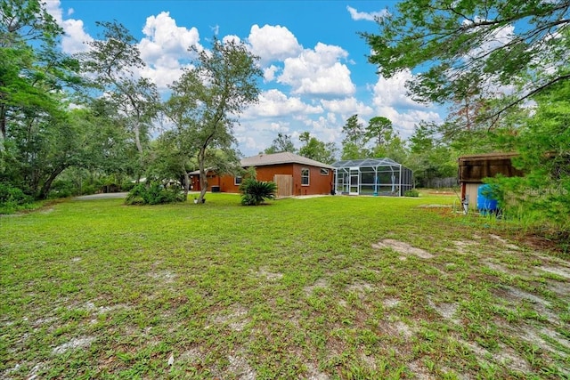 9130 Madrid Rd, Weeki Wachee, FL 34613 - view of green lawn featuring a lanai