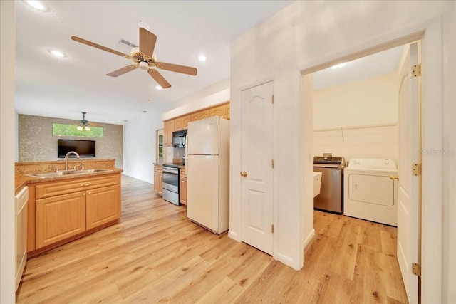 9130 Madrid Rd, Weeki Wachee, FL 34613 - kitchen featuring washer / dryer, freestanding refrigerator, electric range, light wood-type flooring, and recessed lighting