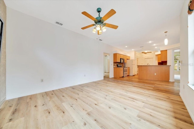 9130 Madrid Rd, Weeki Wachee, FL 34613 - unfurnished living room featuring ceiling fan, light wood finished floors, and recessed lighting