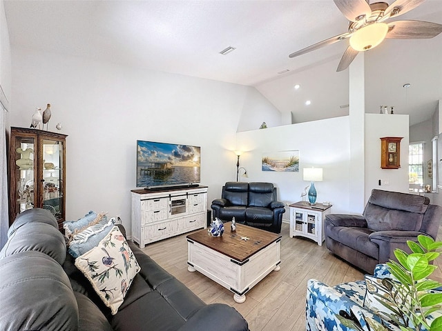 7518 Mediterranean Ct, Hudson, FL 34667 - living area with light wood-style flooring, a ceiling fan, and high vaulted ceiling