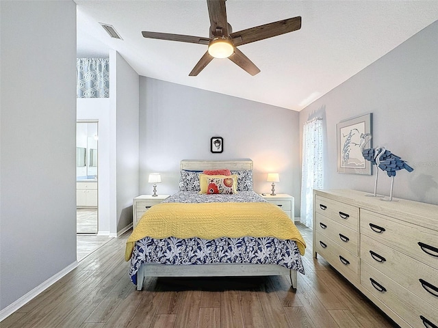 7518 Mediterranean Ct, Hudson, FL 34667 - bedroom with vaulted ceiling, wood finished floors, ceiling fan, and ensuite bathroom