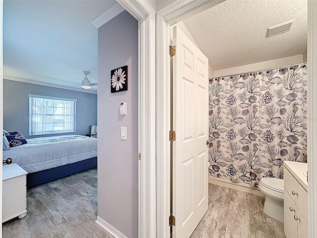 7518 Mediterranean Ct, Hudson, FL 34667 - bathroom with wood finished floors, ensuite bath, vanity, a ceiling fan, and ornamental molding