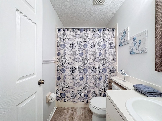7518 Mediterranean Ct, Hudson, FL 34667 - bathroom with vanity, a textured ceiling, a shower with shower curtain, and wood finished floors