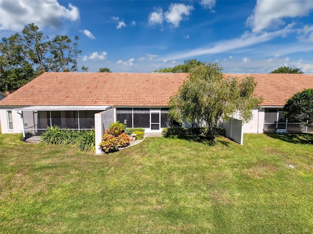 7518 Mediterranean Ct, Hudson, FL 34667 - rear view of property with a sunroom, a yard, and a tile roof