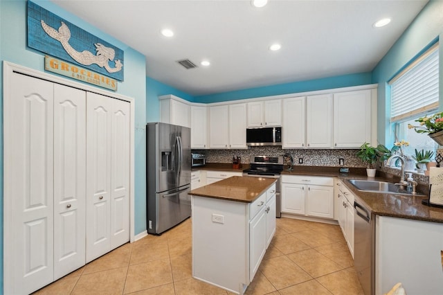 1410 Halapa Way, Trinity, FL 34655 - kitchen with stainless steel appliances, white cabinets, a center island, tasteful backsplash, and recessed lighting
