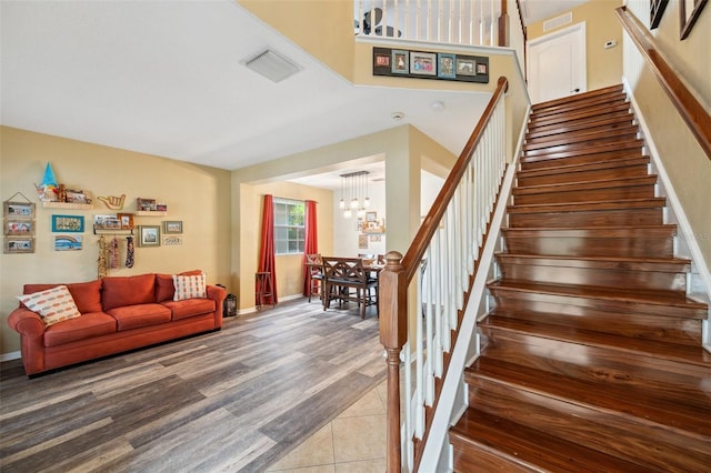 1410 Halapa Way, Trinity, FL 34655 - stairway featuring a chandelier and baseboards