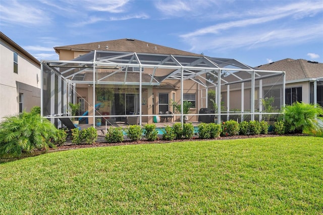 1410 Halapa Way, Trinity, FL 34655 - back of house with a yard, stucco siding, glass enclosure, and a patio