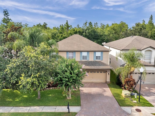 1410 Halapa Way, Trinity, FL 34655 - view of front of home with stucco siding, decorative driveway, a garage, roof with shingles, and a front lawn