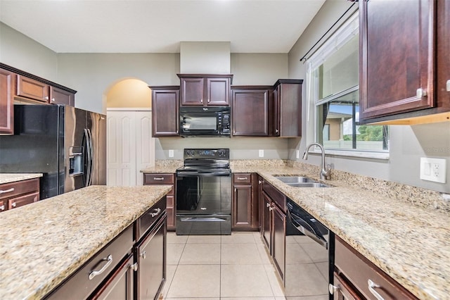 1104 Ketzal Dr, Trinity, FL 34655 - kitchen featuring black appliances, arched walkways, light stone counters, and light tile patterned floors