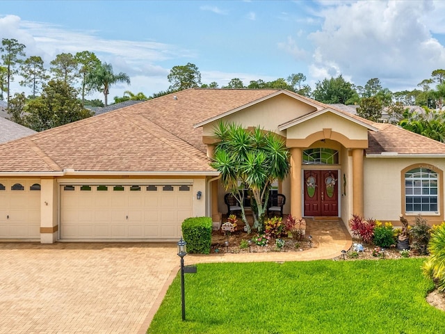 11144 Brambleleaf Way, Hudson, FL 34667 - ranch-style house featuring stucco siding, a front yard, and decorative driveway