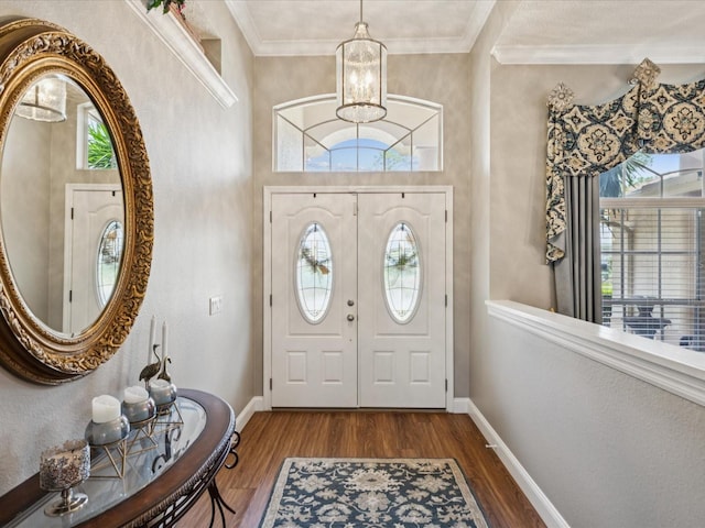 11144 Brambleleaf Way, Hudson, FL 34667 - entrance foyer featuring a chandelier, dark wood-style flooring, and ornamental molding