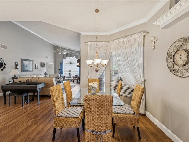 11144 Brambleleaf Way, Hudson, FL 34667 - dining room featuring a chandelier, wood finished floors, ornamental molding, lofted ceiling, and a ceiling fan