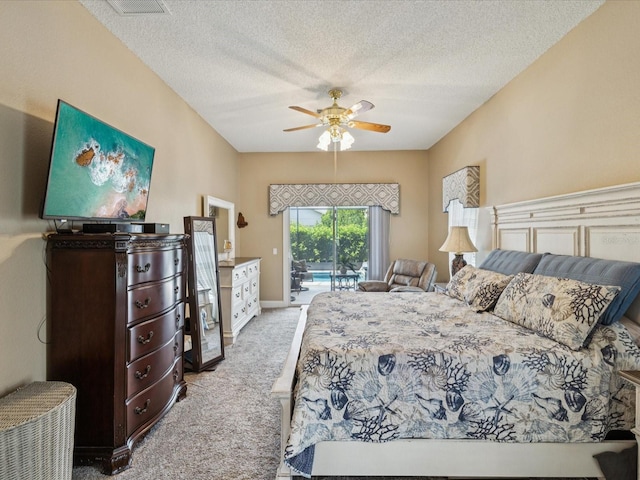 11144 Brambleleaf Way, Hudson, FL 34667 - bedroom with carpet flooring, access to exterior, a textured ceiling, and a ceiling fan