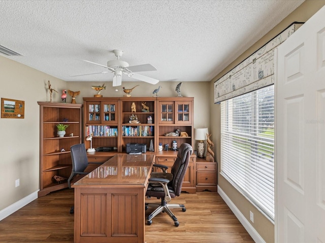 11144 Brambleleaf Way, Hudson, FL 34667 - office featuring a ceiling fan, wood finished floors, and a textured ceiling