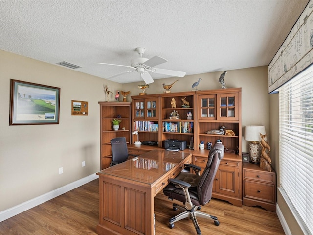 11144 Brambleleaf Way, Hudson, FL 34667 - home office with ceiling fan, a textured ceiling, and light wood-type flooring