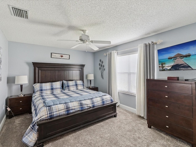 11144 Brambleleaf Way, Hudson, FL 34667 - bedroom with light carpet, a ceiling fan, and a textured ceiling