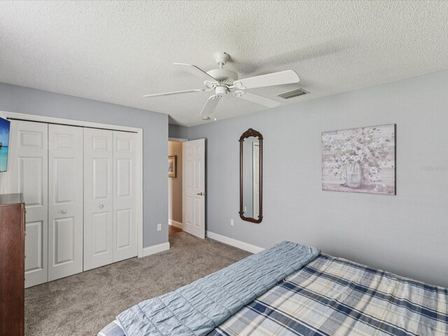 11144 Brambleleaf Way, Hudson, FL 34667 - carpeted bedroom with a closet, a ceiling fan, and a textured ceiling