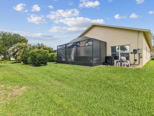 11144 Brambleleaf Way, Hudson, FL 34667 - back of property featuring stucco siding, a lawn, and a lanai