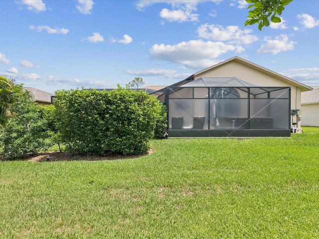 11144 Brambleleaf Way, Hudson, FL 34667 - rear view of property with a lawn, stucco siding, and a lanai