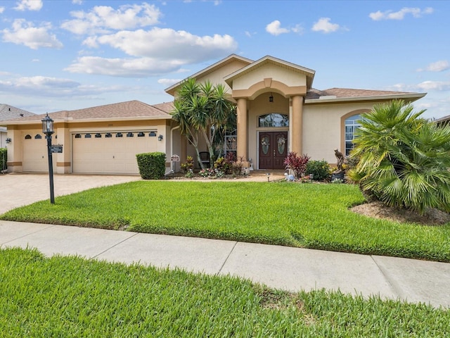 11144 Brambleleaf Way, Hudson, FL 34667 - mediterranean / spanish-style home with stucco siding, a garage, a front yard, and concrete driveway