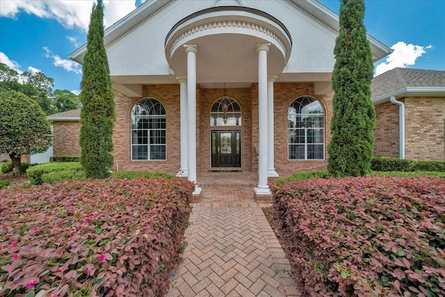 7275 Crystal Spring Run, Weeki Wachee, FL 34607 - doorway to property featuring brick siding and a porch