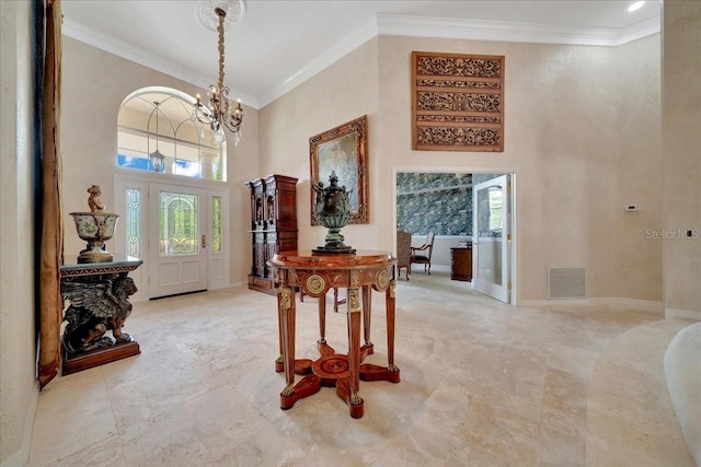 7275 Crystal Spring Run, Weeki Wachee, FL 34607 - entryway featuring a chandelier, a high ceiling, healthy amount of natural light, and crown molding