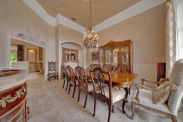 7275 Crystal Spring Run, Weeki Wachee, FL 34607 - dining area with a chandelier, a towering ceiling, and light tile patterned flooring