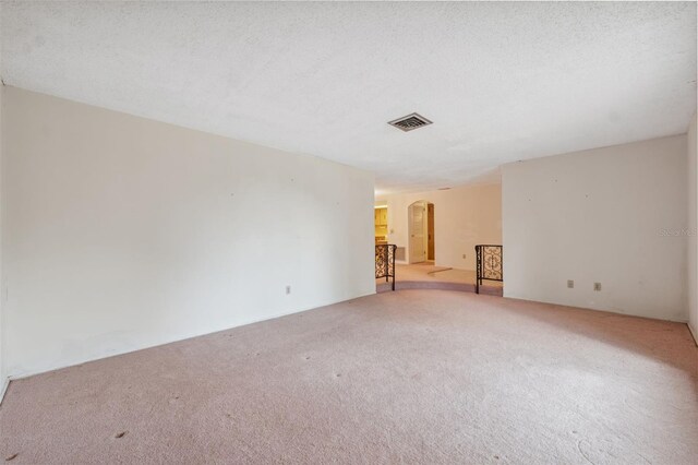 8340 Saint Marks Ct, Hudson, FL 34667 - unfurnished room featuring arched walkways and carpet floors