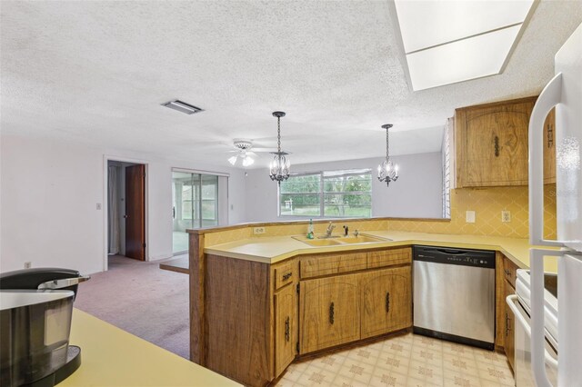 8340 Saint Marks Ct, Hudson, FL 34667 - kitchen featuring stainless steel dishwasher, a peninsula, brown cabinetry, light countertops, and a textured ceiling