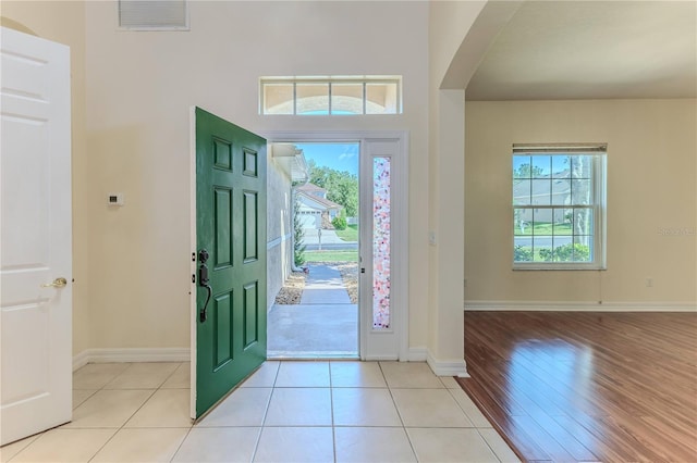 13772 Dunwoody Dr, Spring Hill, FL 34609 - foyer featuring arched walkways, healthy amount of natural light, and light wood-style flooring