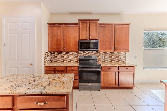 13772 Dunwoody Dr, Spring Hill, FL 34609 - kitchen with stainless steel appliances, brown cabinetry, decorative backsplash, and light stone counters