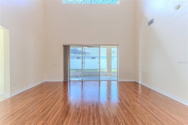13772 Dunwoody Dr, Spring Hill, FL 34609 - empty room featuring a towering ceiling and wood finished floors