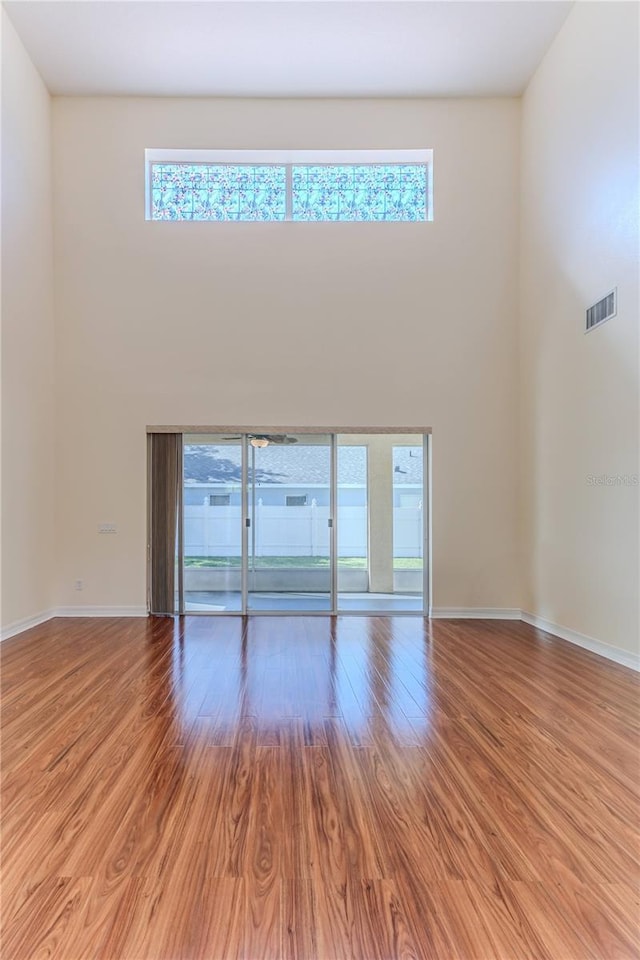 13772 Dunwoody Dr, Spring Hill, FL 34609 - unfurnished room featuring a towering ceiling, plenty of natural light, and light wood-type flooring