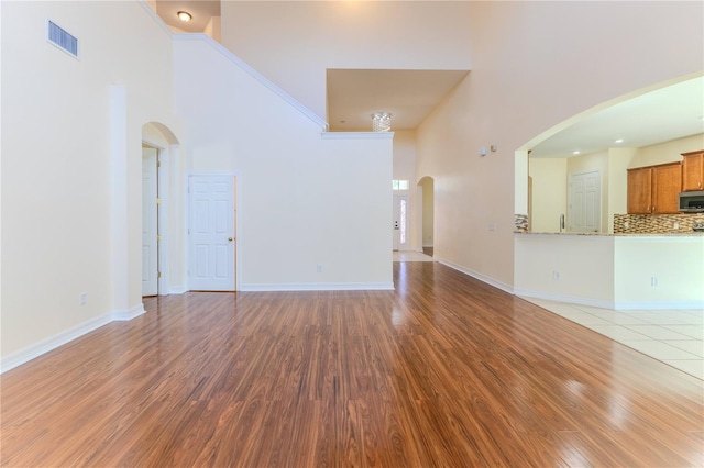 13772 Dunwoody Dr, Spring Hill, FL 34609 - unfurnished living room featuring a high ceiling and wood finished floors