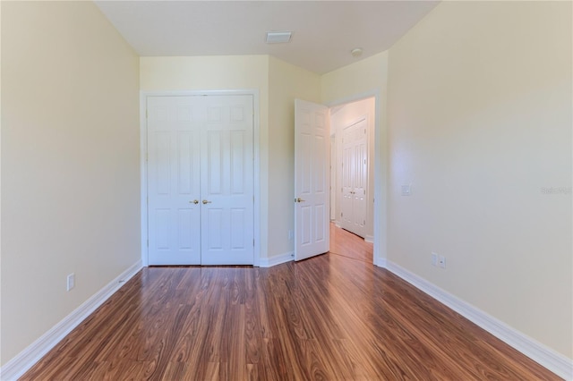 13772 Dunwoody Dr, Spring Hill, FL 34609 - unfurnished bedroom with dark wood-style floors and a closet