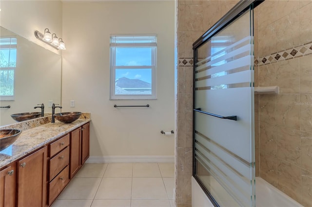 13772 Dunwoody Dr, Spring Hill, FL 34609 - bathroom with tile patterned flooring, healthy amount of natural light, double vanity, and combined bath / shower with glass door