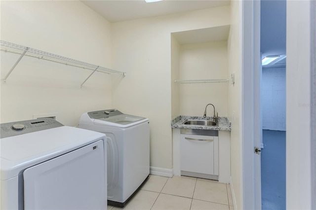 13772 Dunwoody Dr, Spring Hill, FL 34609 - laundry room featuring washer and clothes dryer and light tile patterned flooring