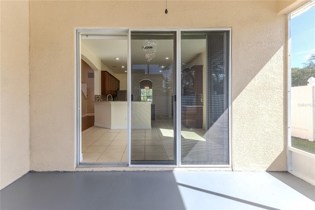 13772 Dunwoody Dr, Spring Hill, FL 34609 - doorway to property featuring stucco siding and a sink